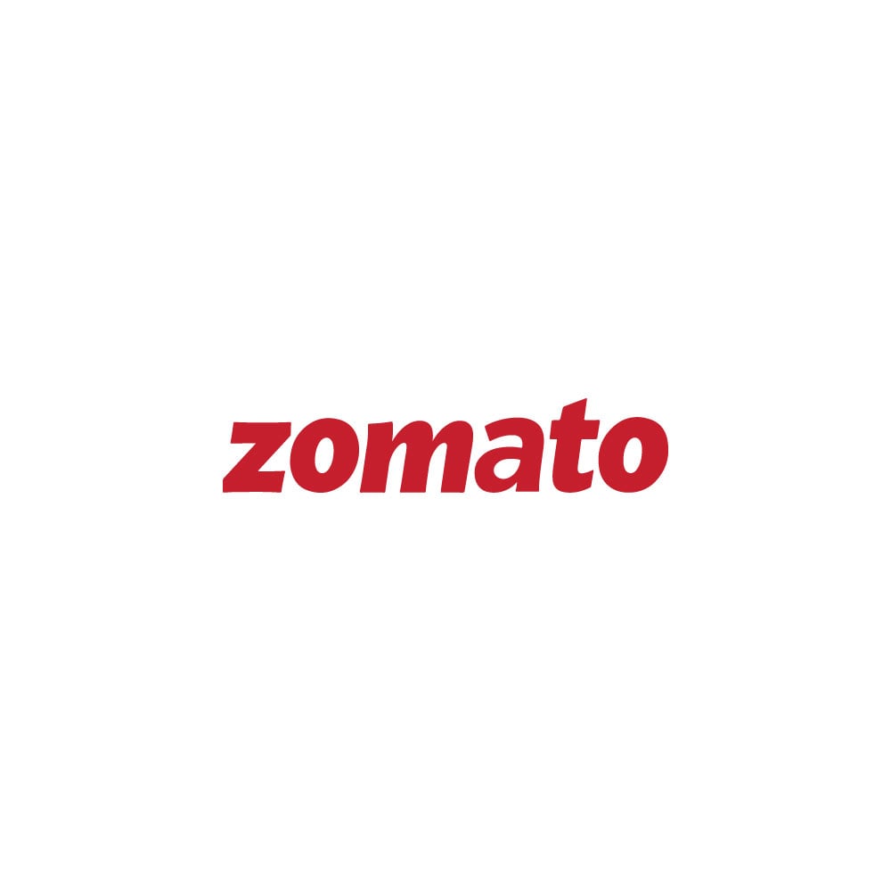 A smartphone showing the Zomato logo rests on a plain wooden table  (Editorial use only Stock Photo - Alamy